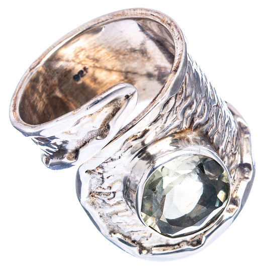 Sterling silver ring showing inner band and oval green gemstone with raised frame
