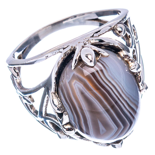 Oval gray striped agate in a sterling silver ring with detailed side and prong design