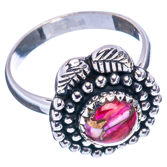 Sterling silver ring with oval pink cabochon, bead border, and leaf motif on band