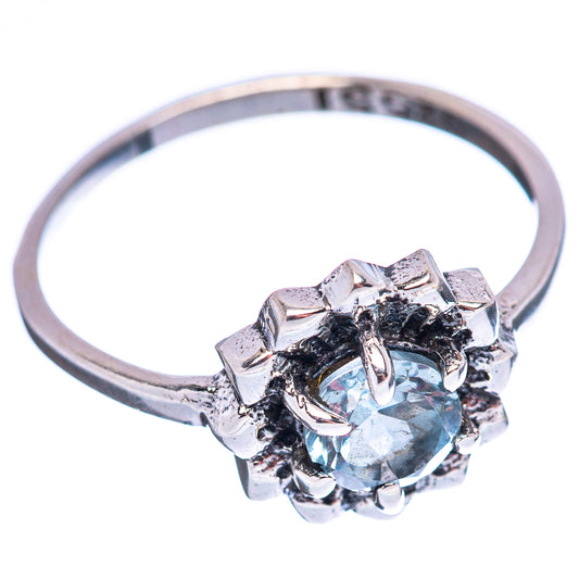 Sterling silver ring with round light blue topaz and star-like halo, side view