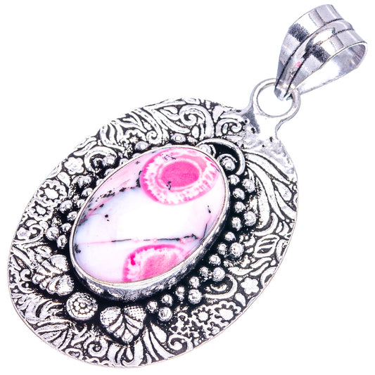 Silver-tone oval opal pendant with pink dendritic stone in ornate teardrop setting