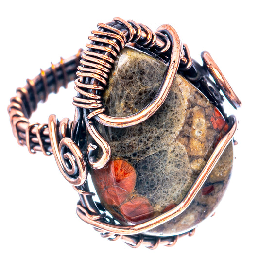 Oxidized copper wire wrap ring featuring dark stone with red flecks and scalloped frame