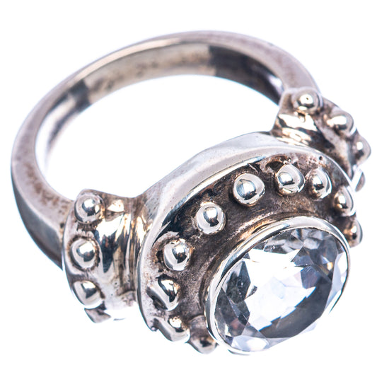 Sterling silver ring with round clear gemstone bezel and raised side bead accents