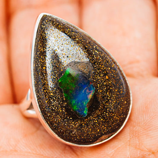 Teardrop boulder opal ring with green and blue highlights, dark speckled bezel in .925 silver