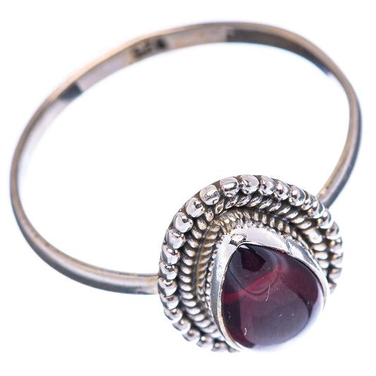 Sterling silver ring with dark red oval cabochon, textured rope bezel and open view