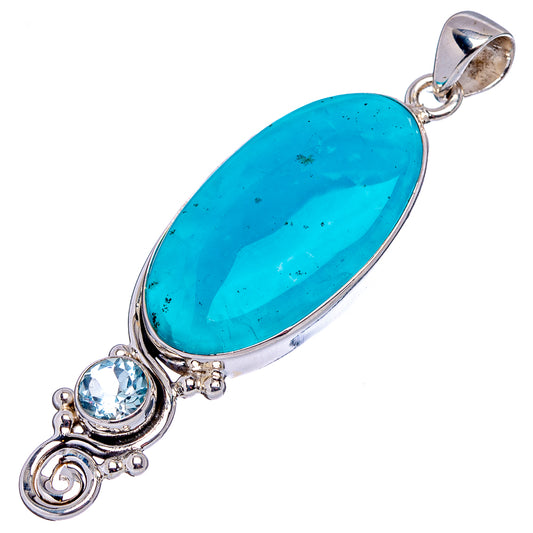 Long oval blue gemstone pendant with round blue accent stones in sterling silver setting