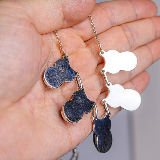 Turquoise teardrop pendant necklace with textured .925 sterling silver chain, close-up