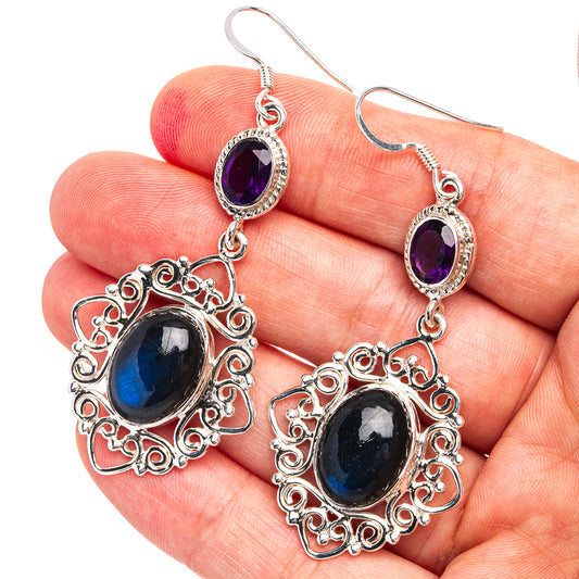 Ornate sterling silver drop earrings featuring purple amethyst top and blue labradorite center