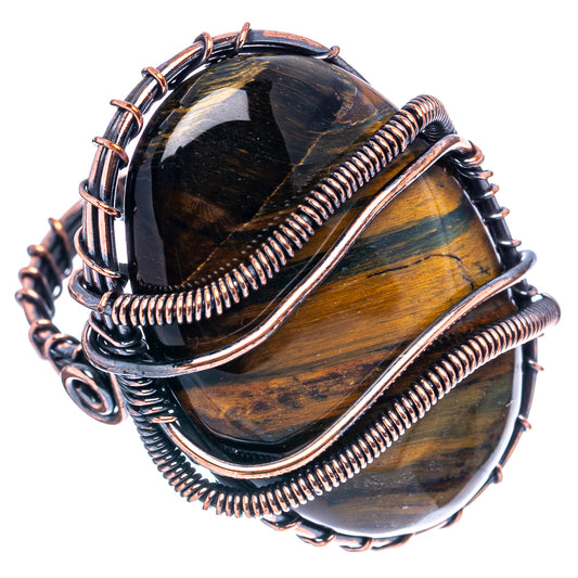 Oxidized copper wire-wrap ring with oval blue-gold tiger eye stone