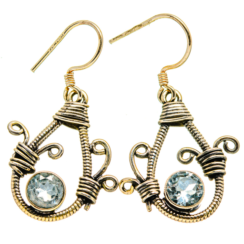 Pair of gold-tone blue gemstone drop earrings with ornate wirework and fishhook backs