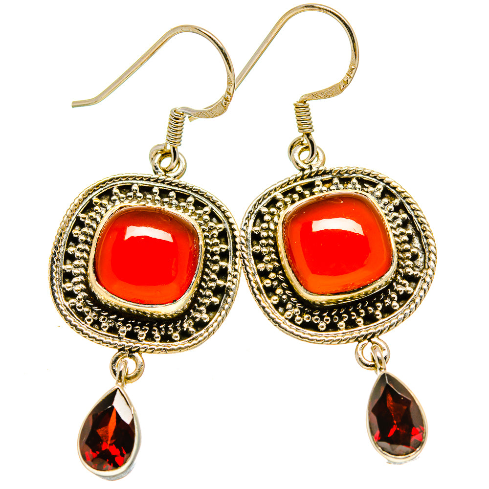 Gold-tone drop earrings with red round cabochons, detailed frame, and red teardrop charms
