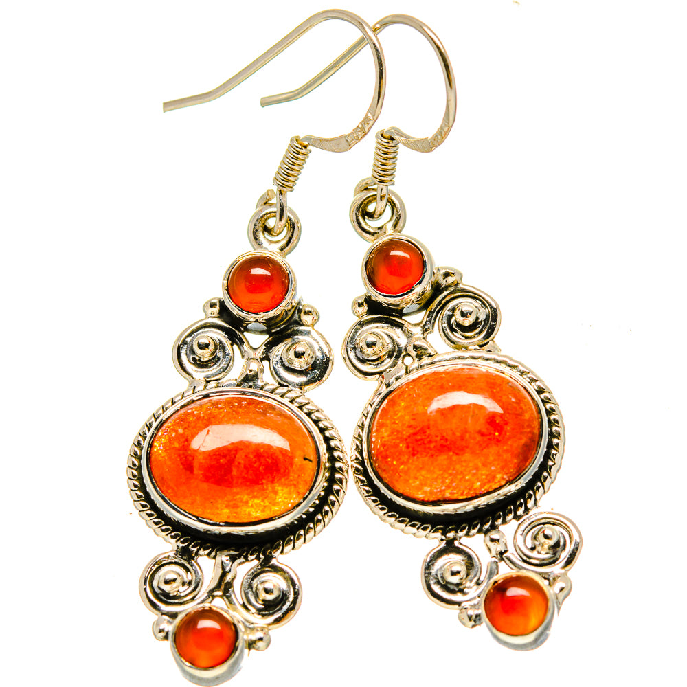 Carnelian drop earrings with large orange oval stone, ornate silver-tone setting and small beads