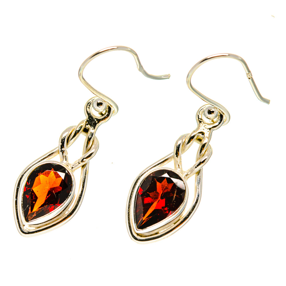 Garnet teardrop earrings in 925 sterling silver with dangling faceted red stones on hooks.