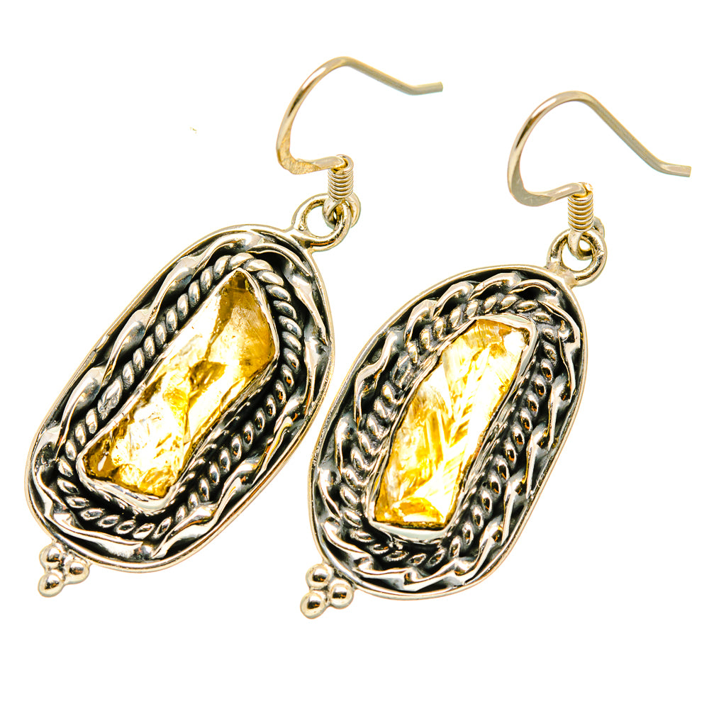 Hook drop earrings with ornate silver oval frames and rough yellow citrine stones