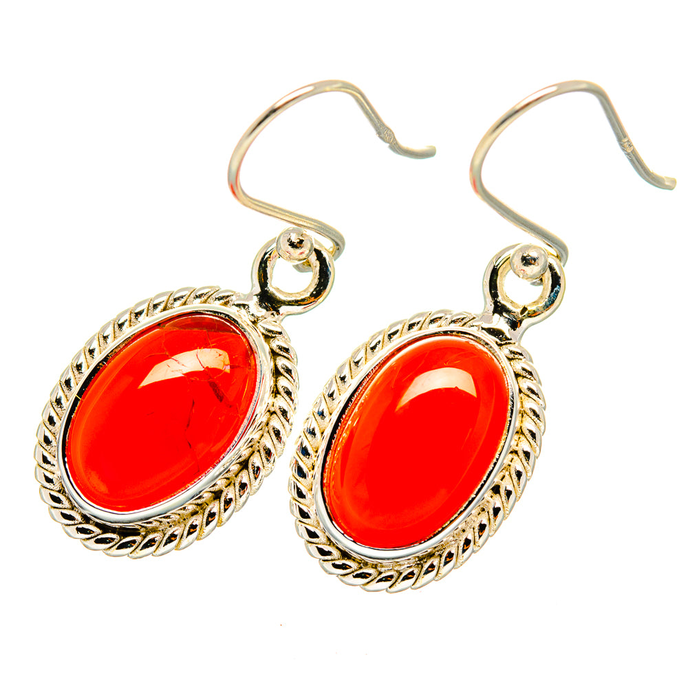 Red oval onyx drop earrings with textured edge frame and silver-tone hooks