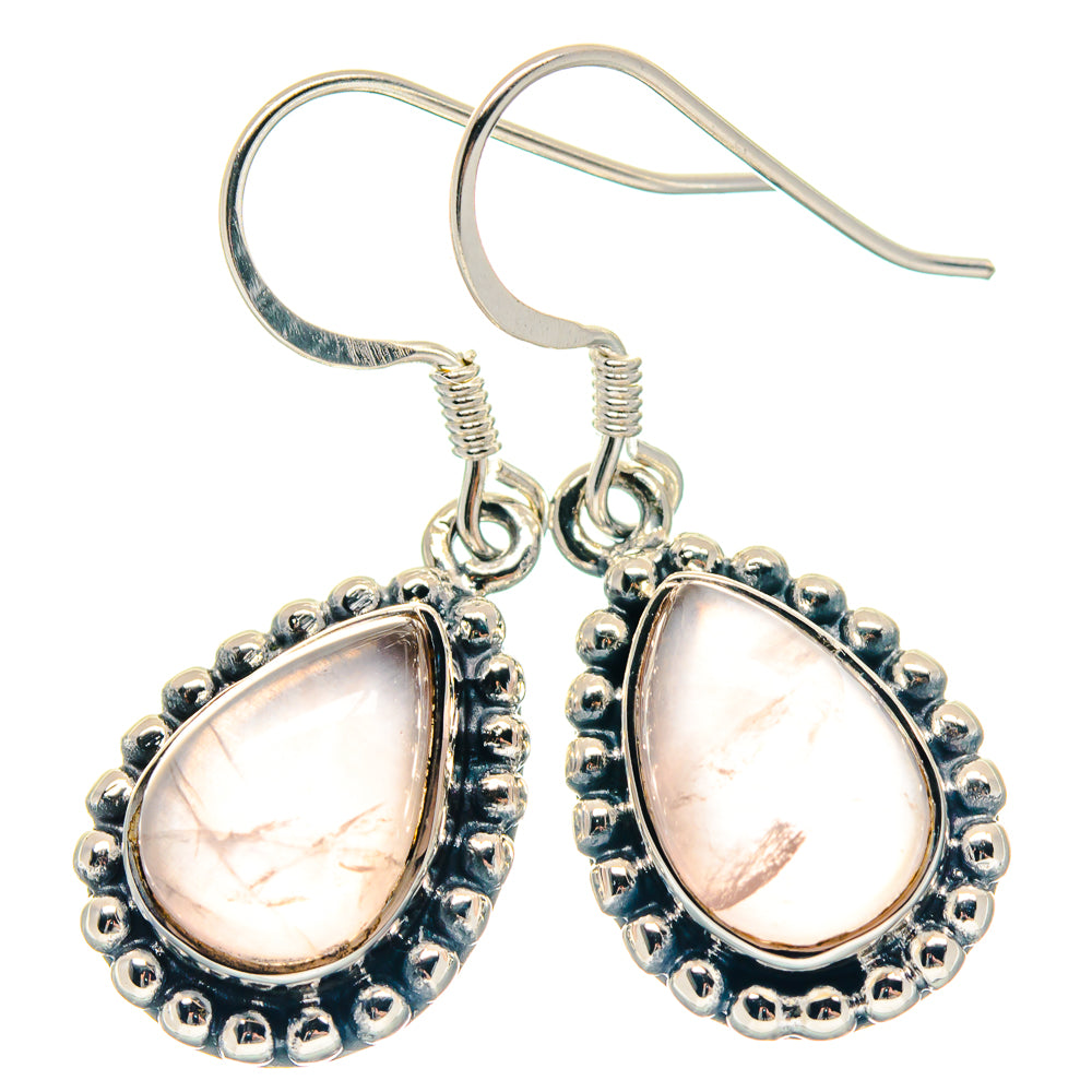 Rose quartz teardrop earrings with silver-tone scalloped bezel and visible ear wires