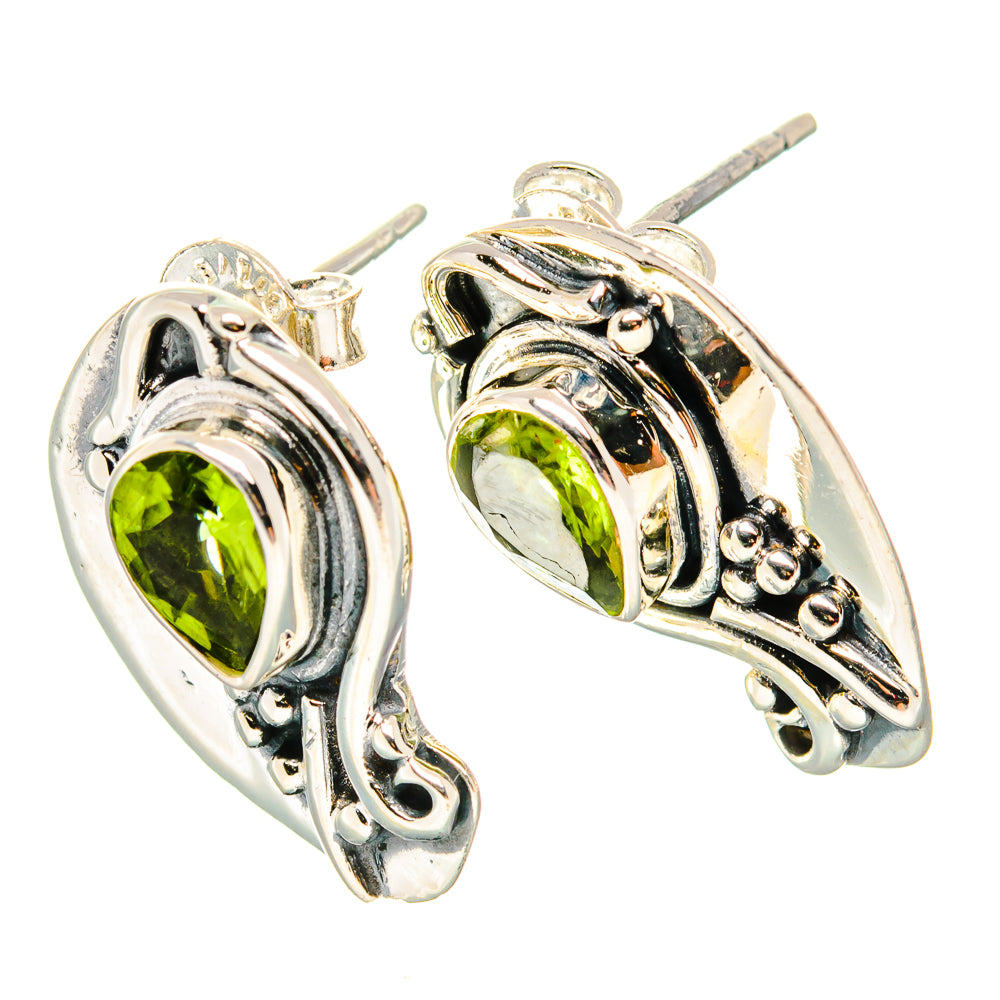 925 sterling silver peridot earrings with teardrop bezels and decorative scrollwork