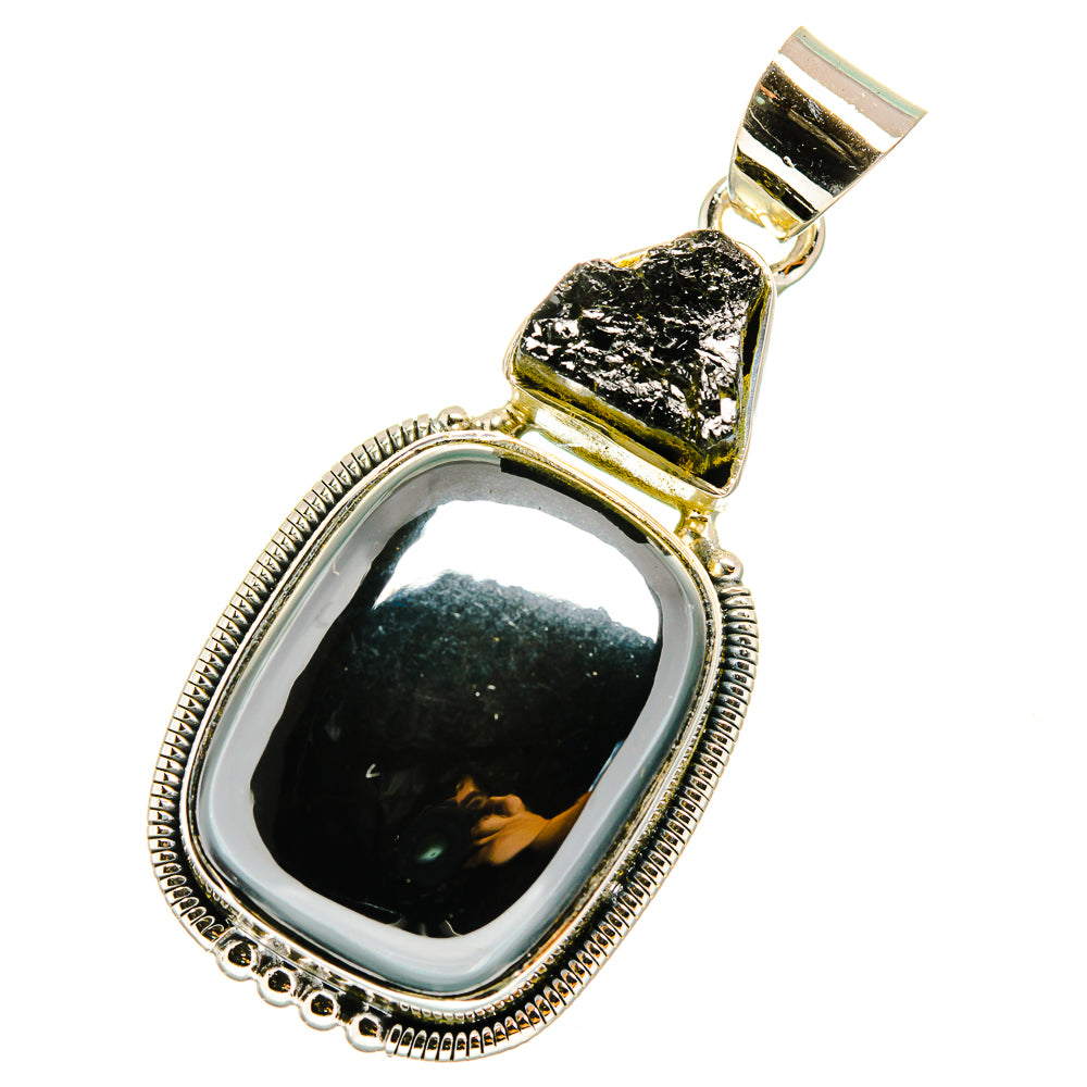 Black gemstone pendant with polished silver frame and textured top stone, oval setting