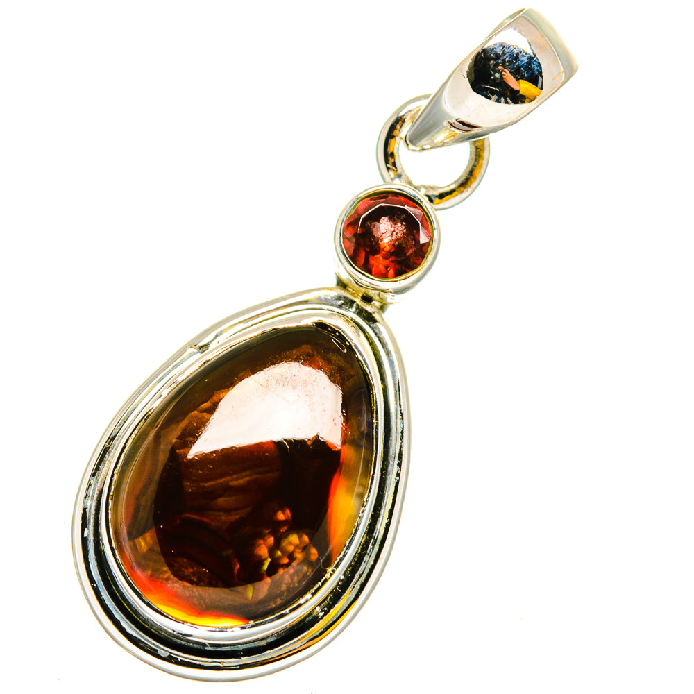 Sterling silver pendant with large oval amber stone, round red gem, and bail loop