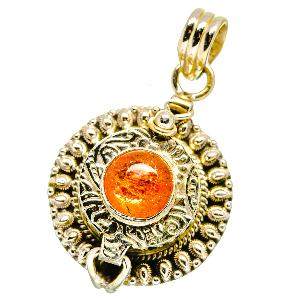 Round sunstone poison pendant with orange cabochon, decorative filigree border and bail