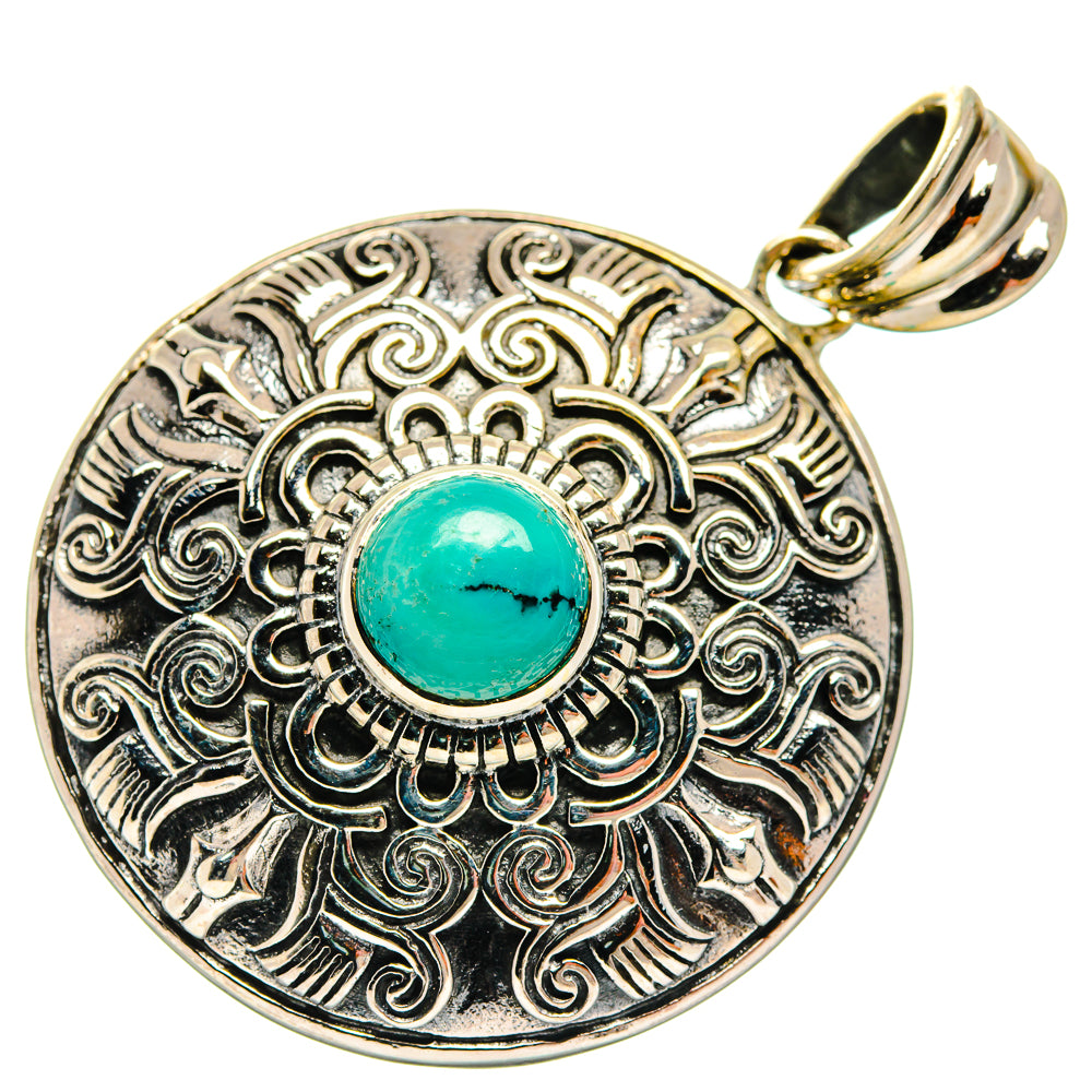 Round silver-tone pendant with turquoise cabochon and filigree edge; gold bail