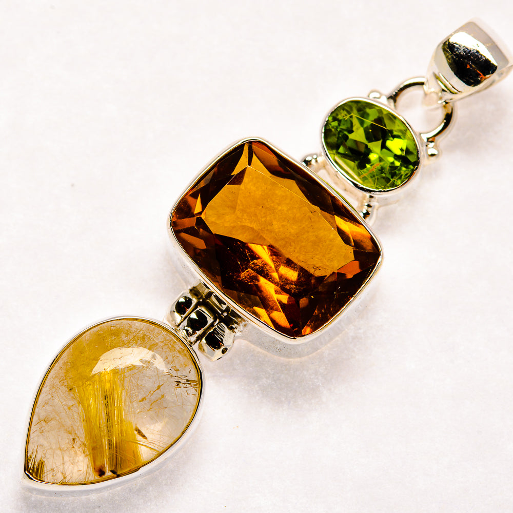 Sterling silver gemstone pendant with amber marquise, green oval, and golden teardrop stones