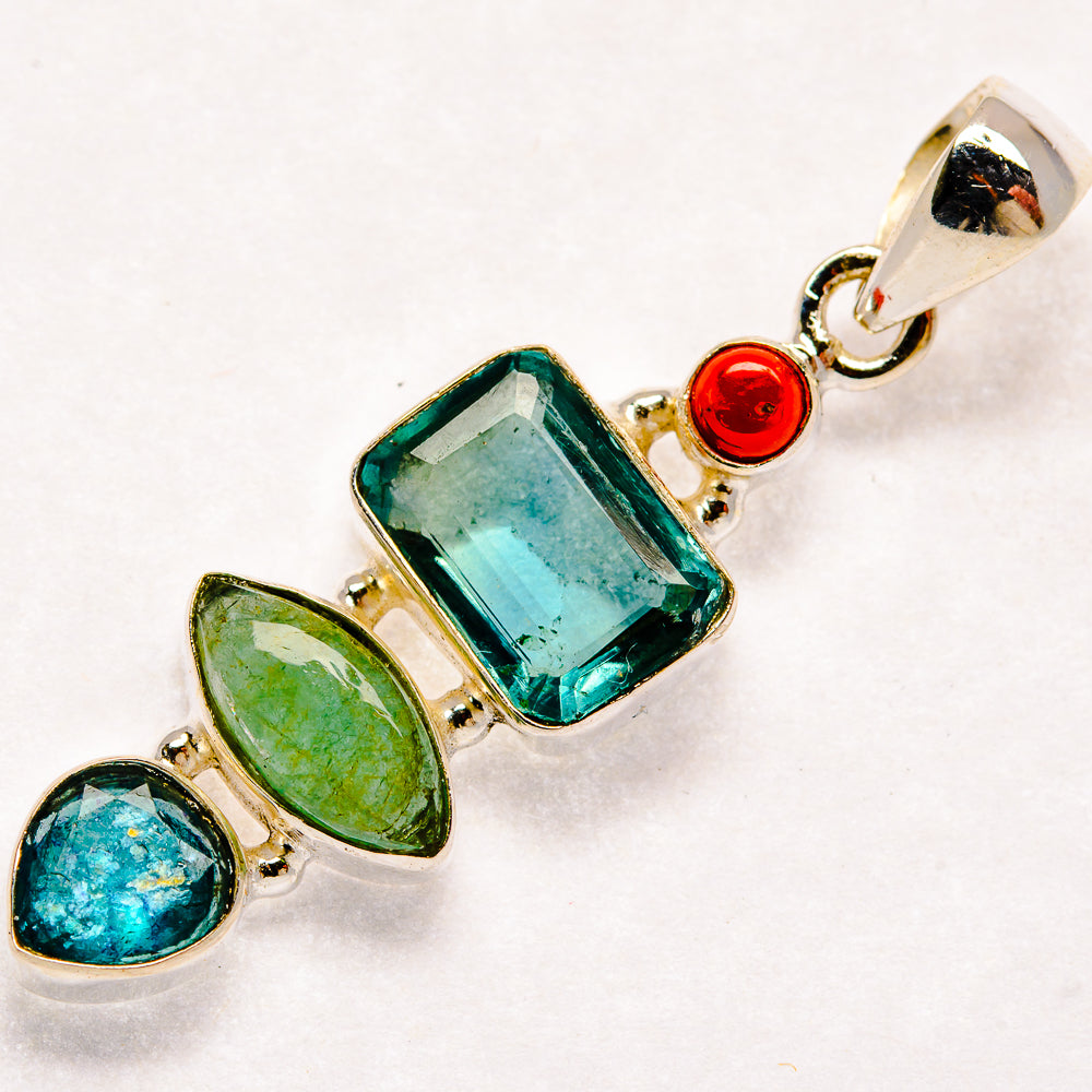 Sterling silver pendant with faceted teal stone, green and blue ovals, red accents