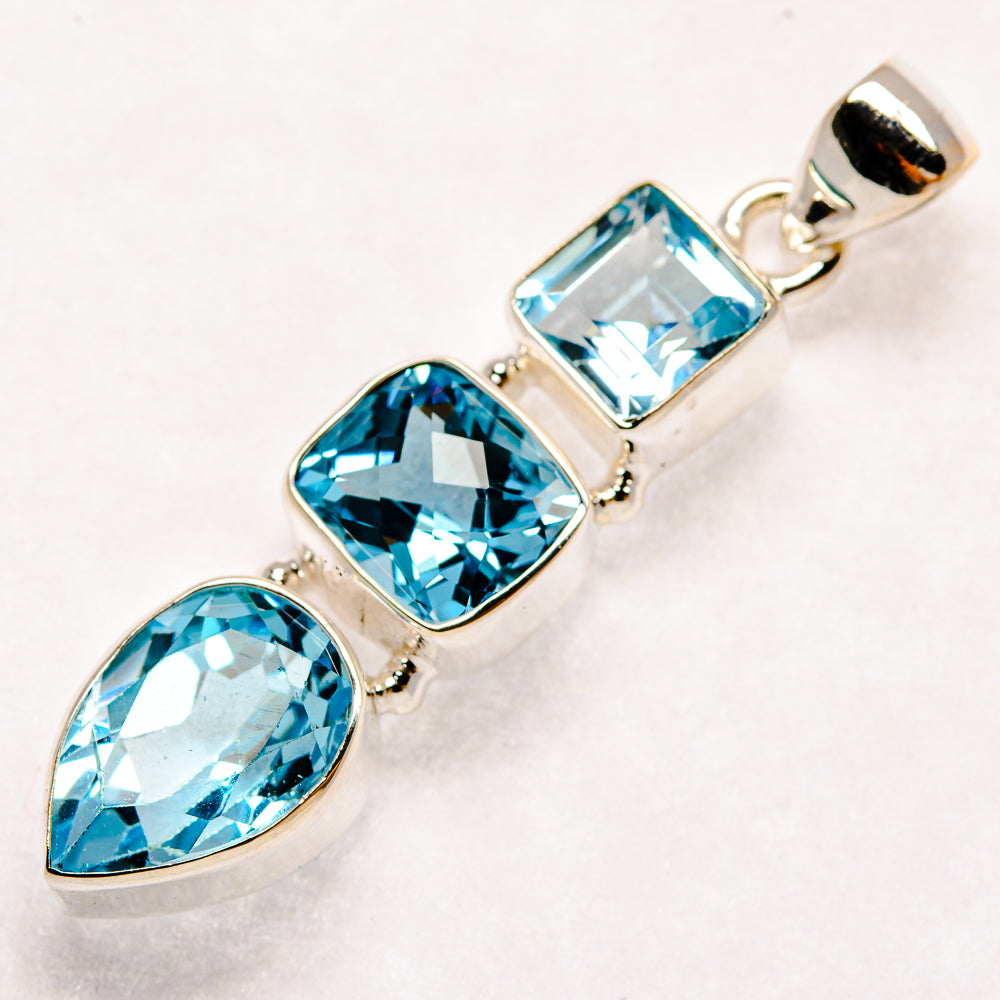 Sterling silver pendant with three faceted blue gemstones in mixed shapes