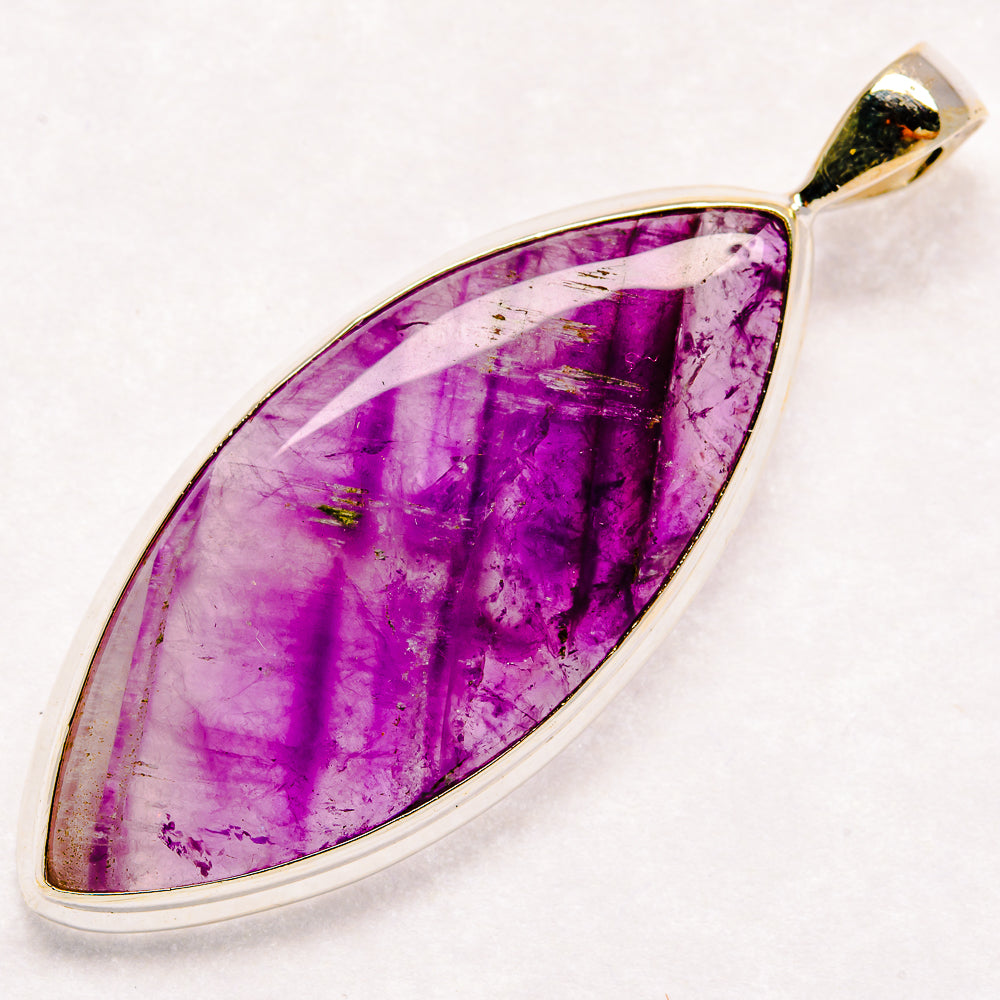 Sterling silver amethyst pendant with purple marquise cabochon in open chevron setting