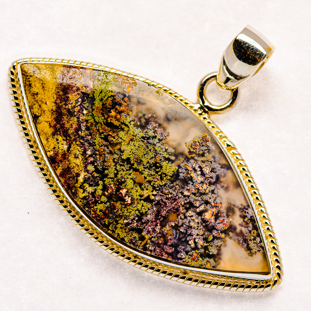 Teardrop plume agate pendant in silver-tone bezel with multicolor streaks and loop bail.