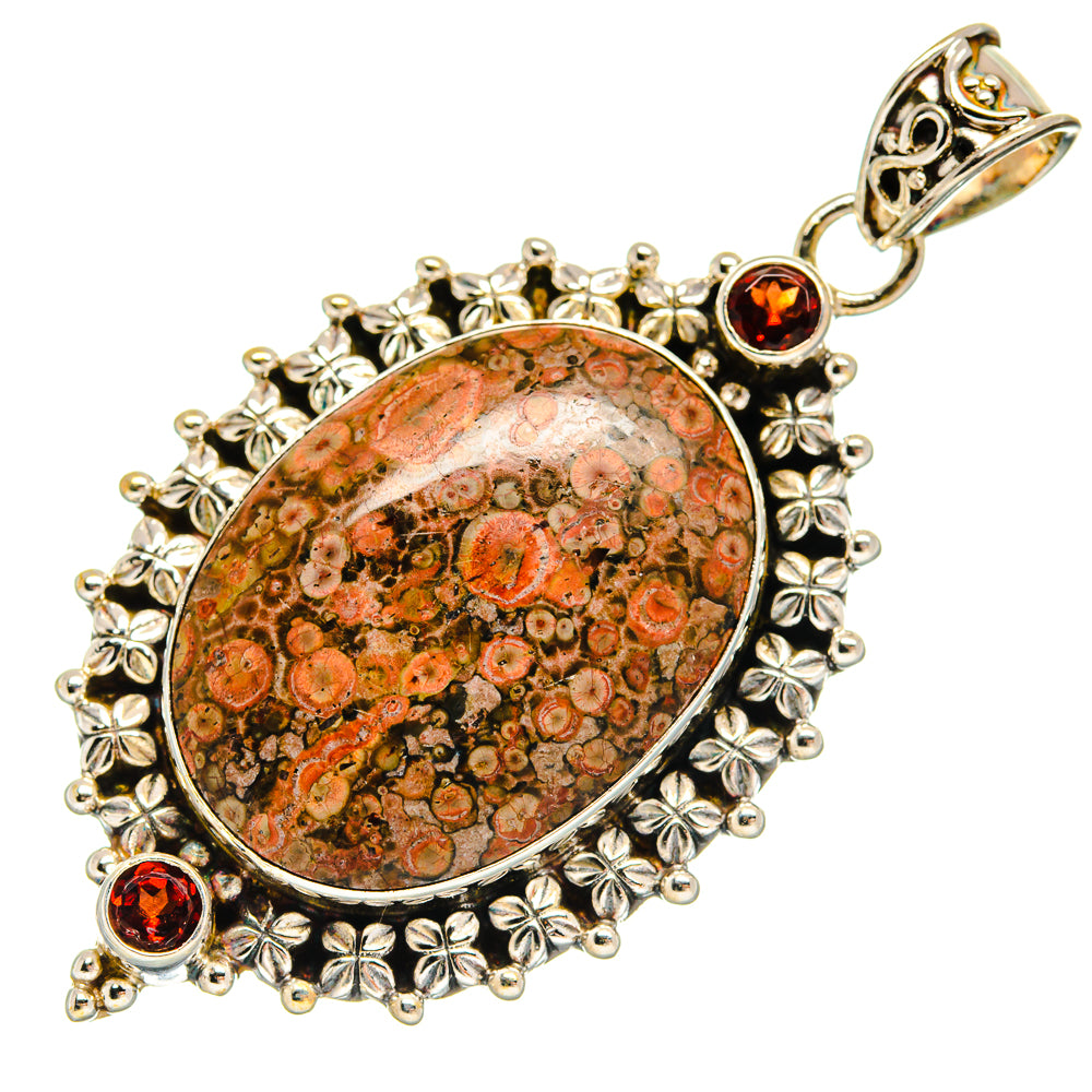 Oval poppy jasper pendant in 925 sterling silver with ornate leaf frame and small round garnets.