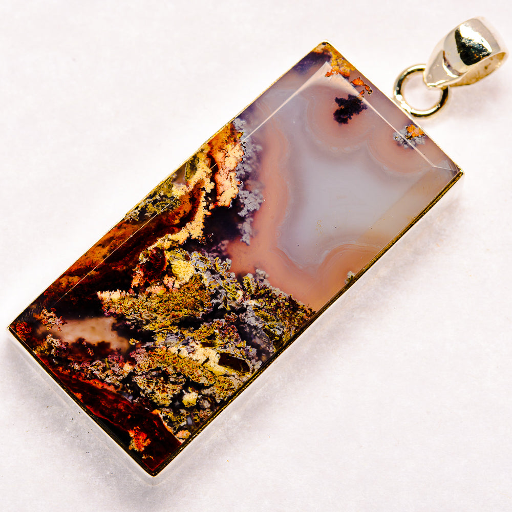 Rectangular plume agate pendant, silver bail, purple-blue stone with gold flecks.