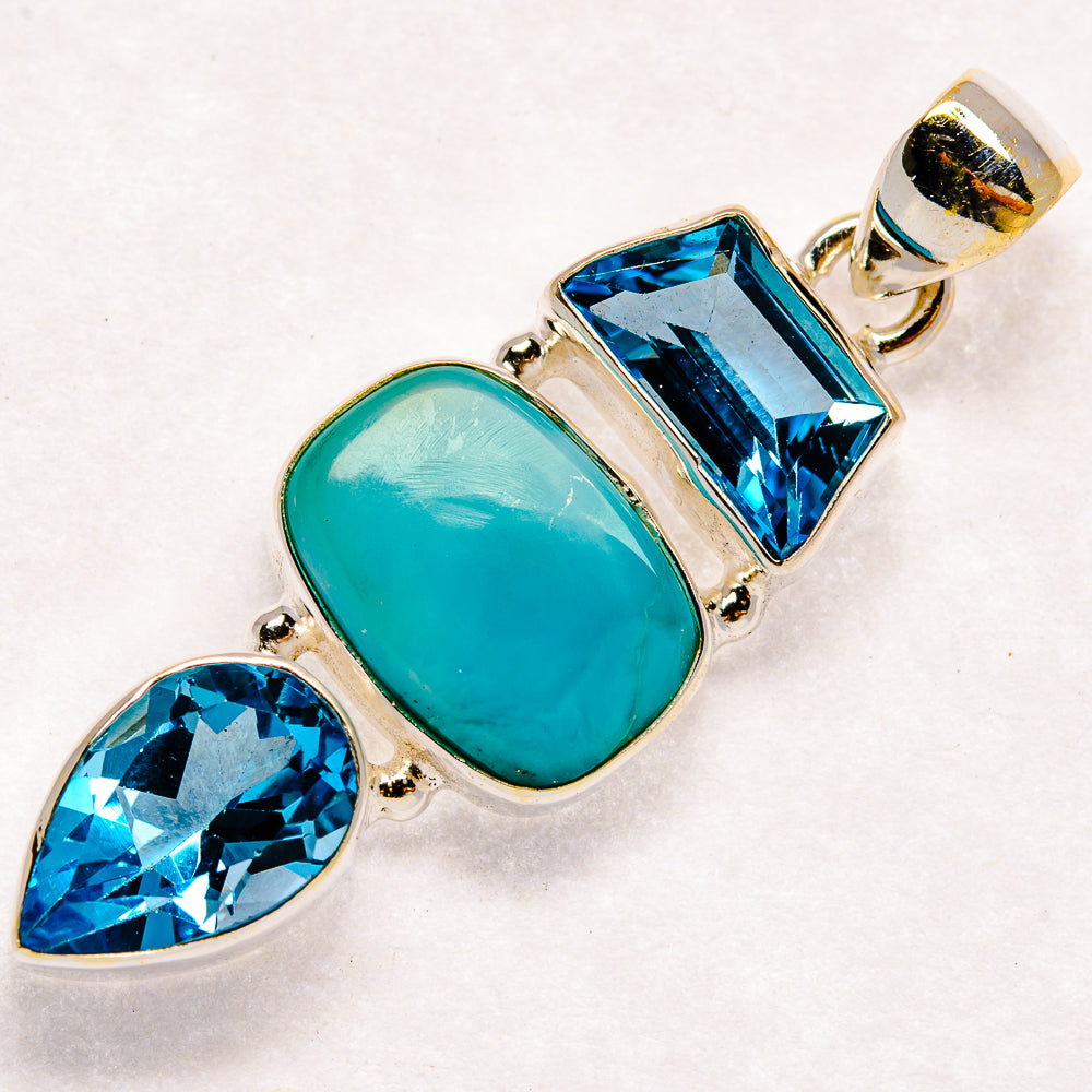 Sterling silver pendant with oval larimar and faceted blue topaz stones, silver bail at top