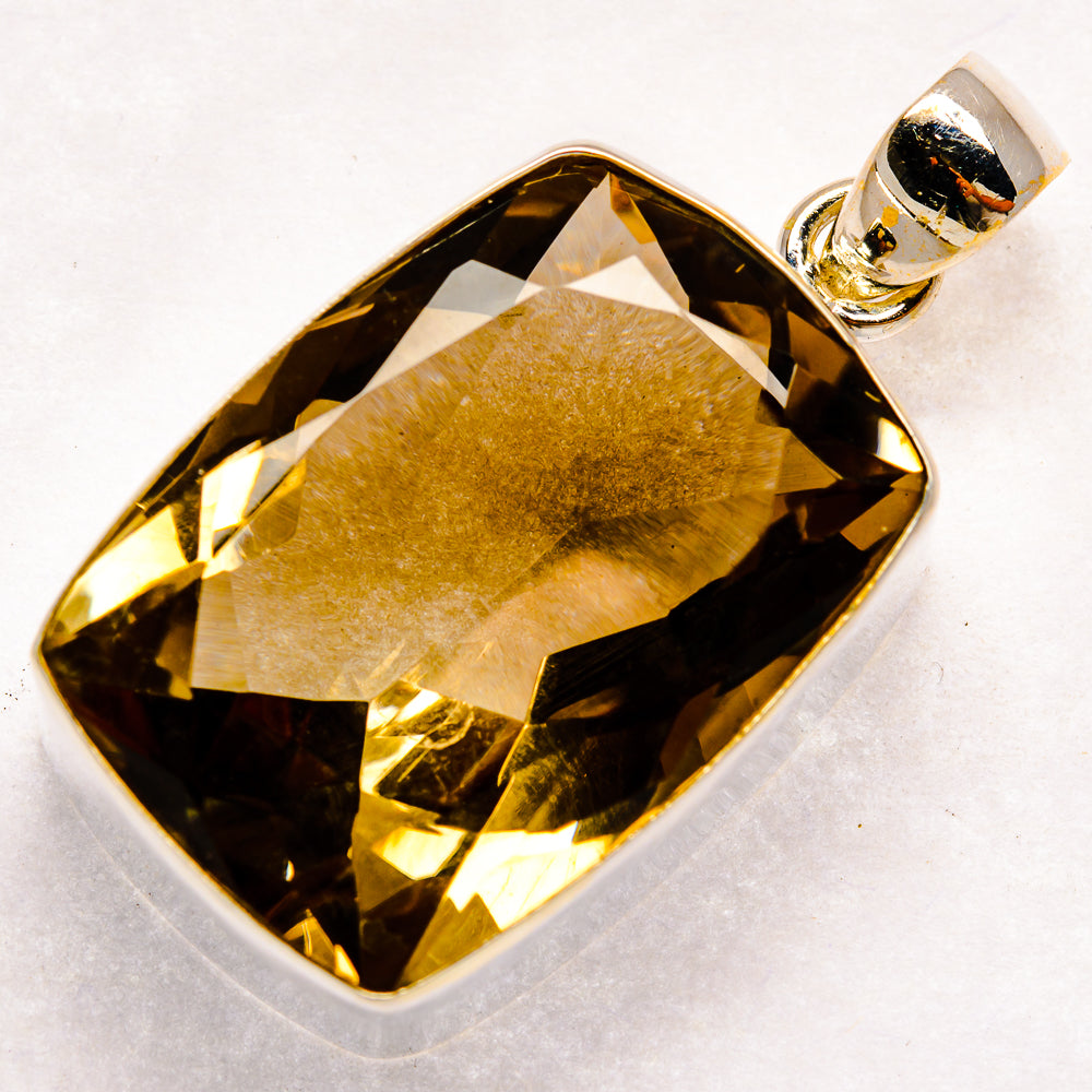 Smoky quartz pendant with faceted dark brown gemstone in silver bezel and loop bail