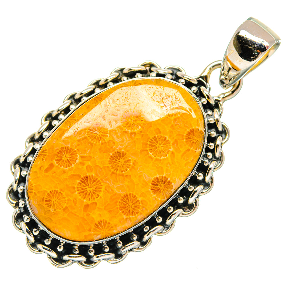 Oval orange coral pendant with decorative silver-tone frame and top bail loop.