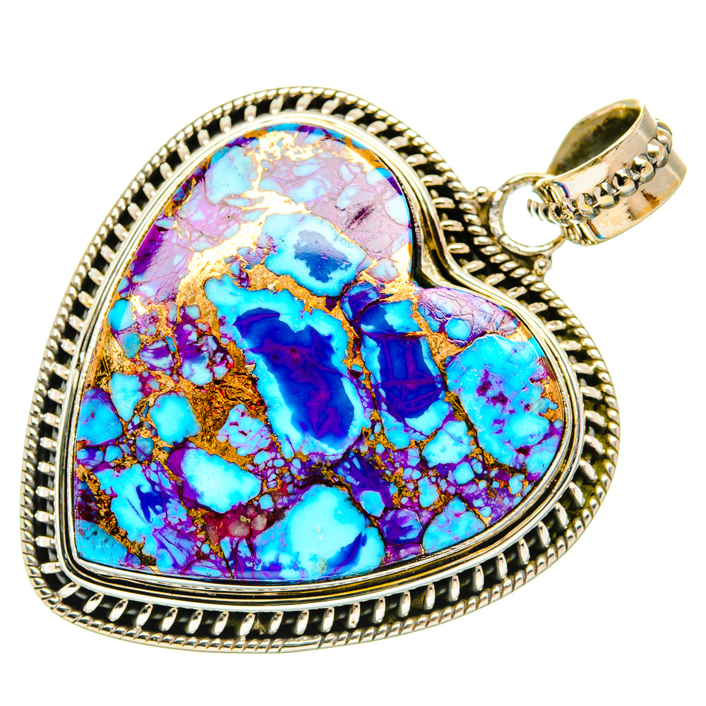 Heart-shaped turquoise inlay pendant with ornate silver-tone border and bail