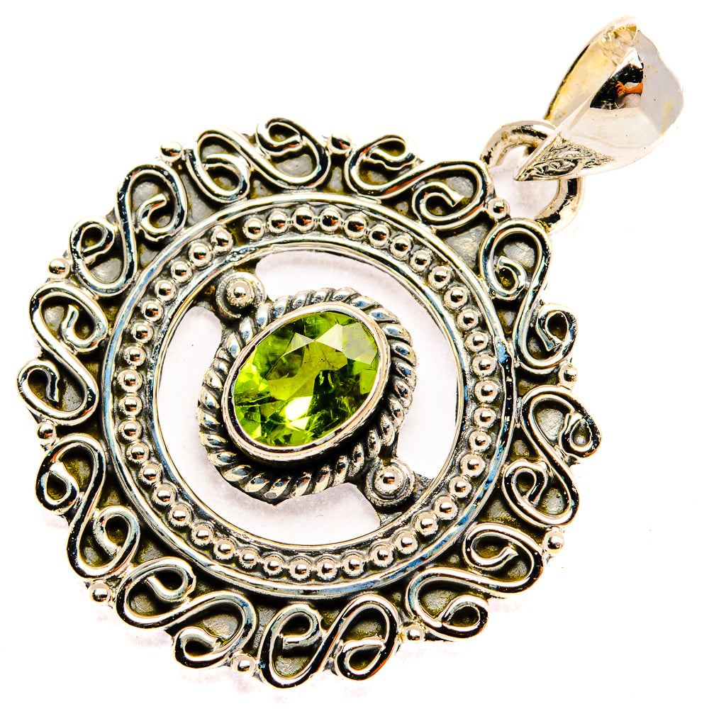 Sterling silver peridot pendant with green stone in ornate filigree oval setting