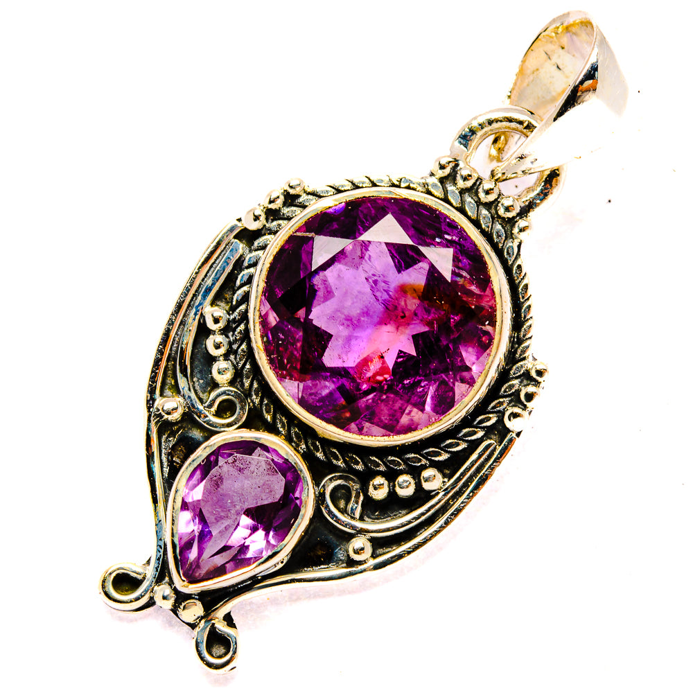 Amethyst pendant with large round faceted purple stone, small oval stone, silver frame and loop