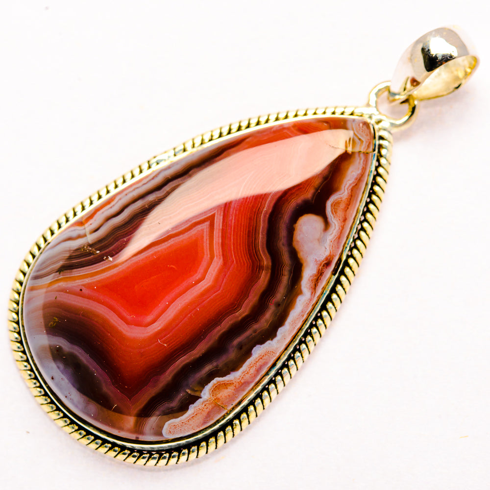 Teardrop red Botswana agate pendant in 925 sterling silver, textured gold-tone bezel