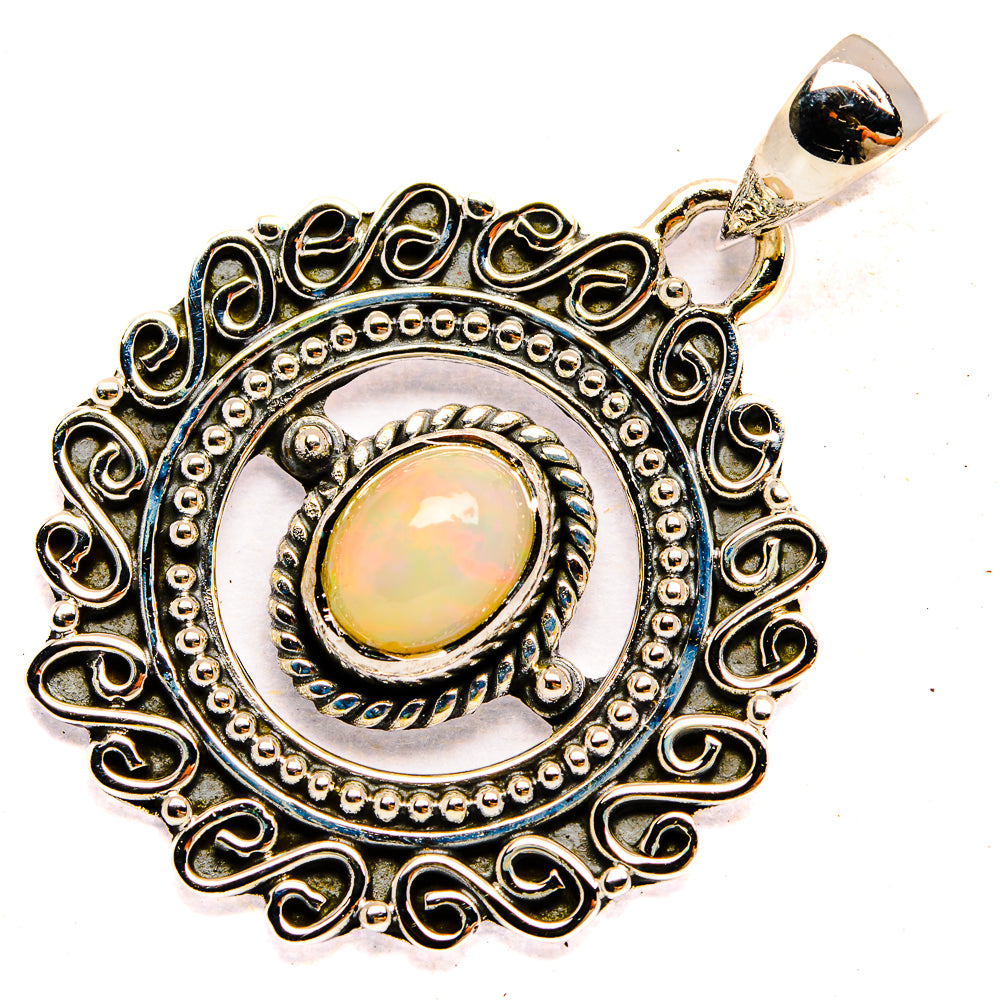 925 sterling silver opal pendant with ornate round frame, oval opal cabochon, and bail