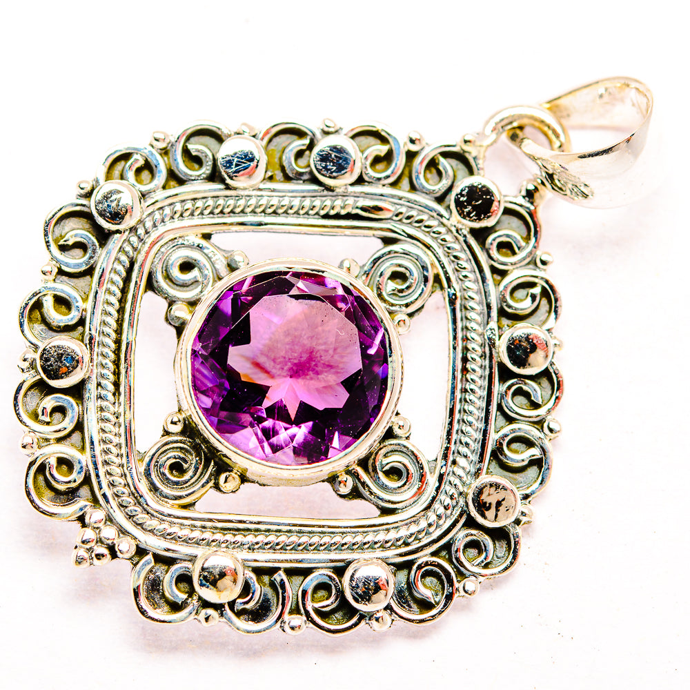 Sterling silver amethyst pendant with faceted purple stone, filigree border, top bail