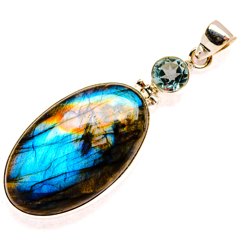 Oval labradorite pendant with bright blue flash and blue topaz stones in 925 silver frame