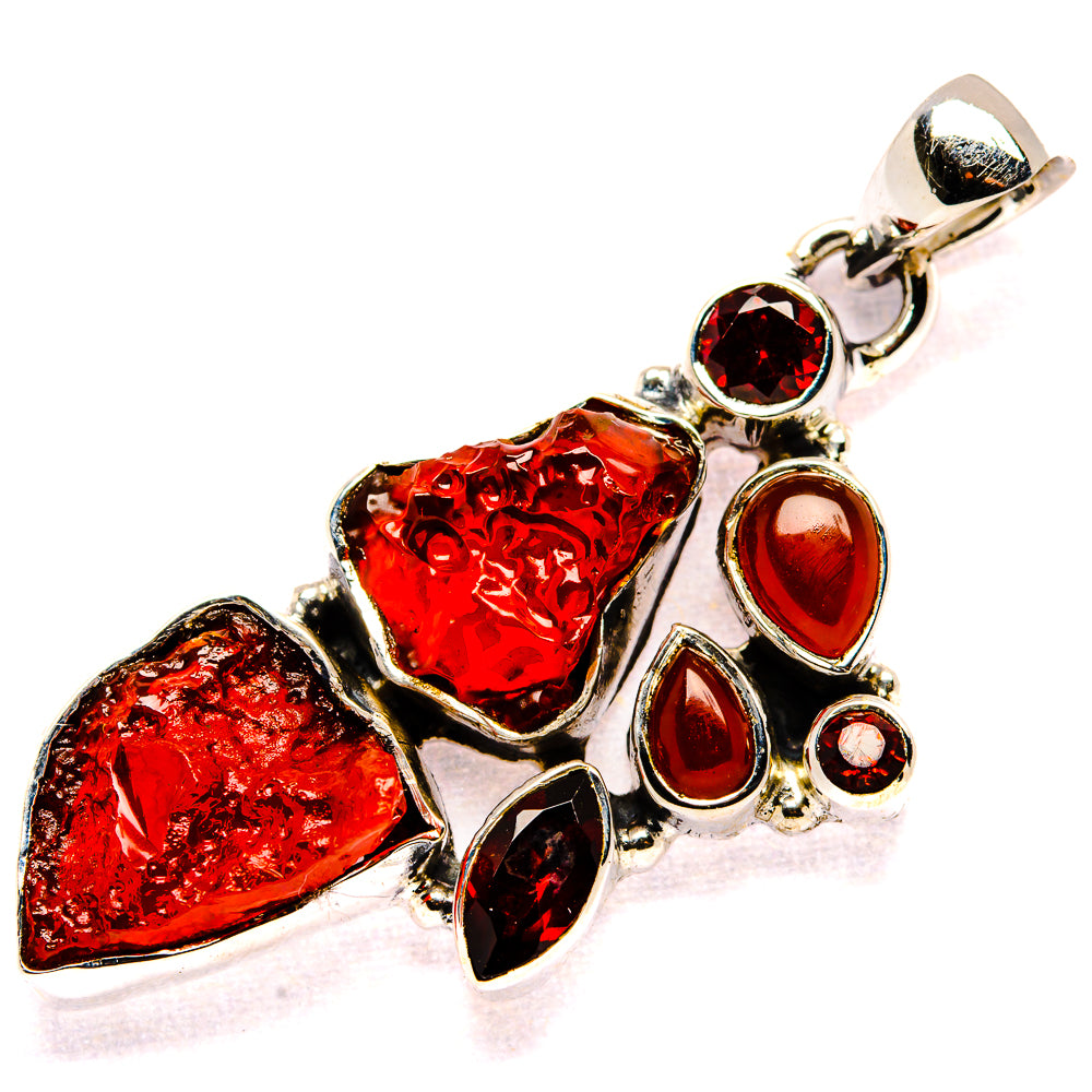 Sterling silver garnet pendant with rough red stones, teardrop highlights, and round accents
