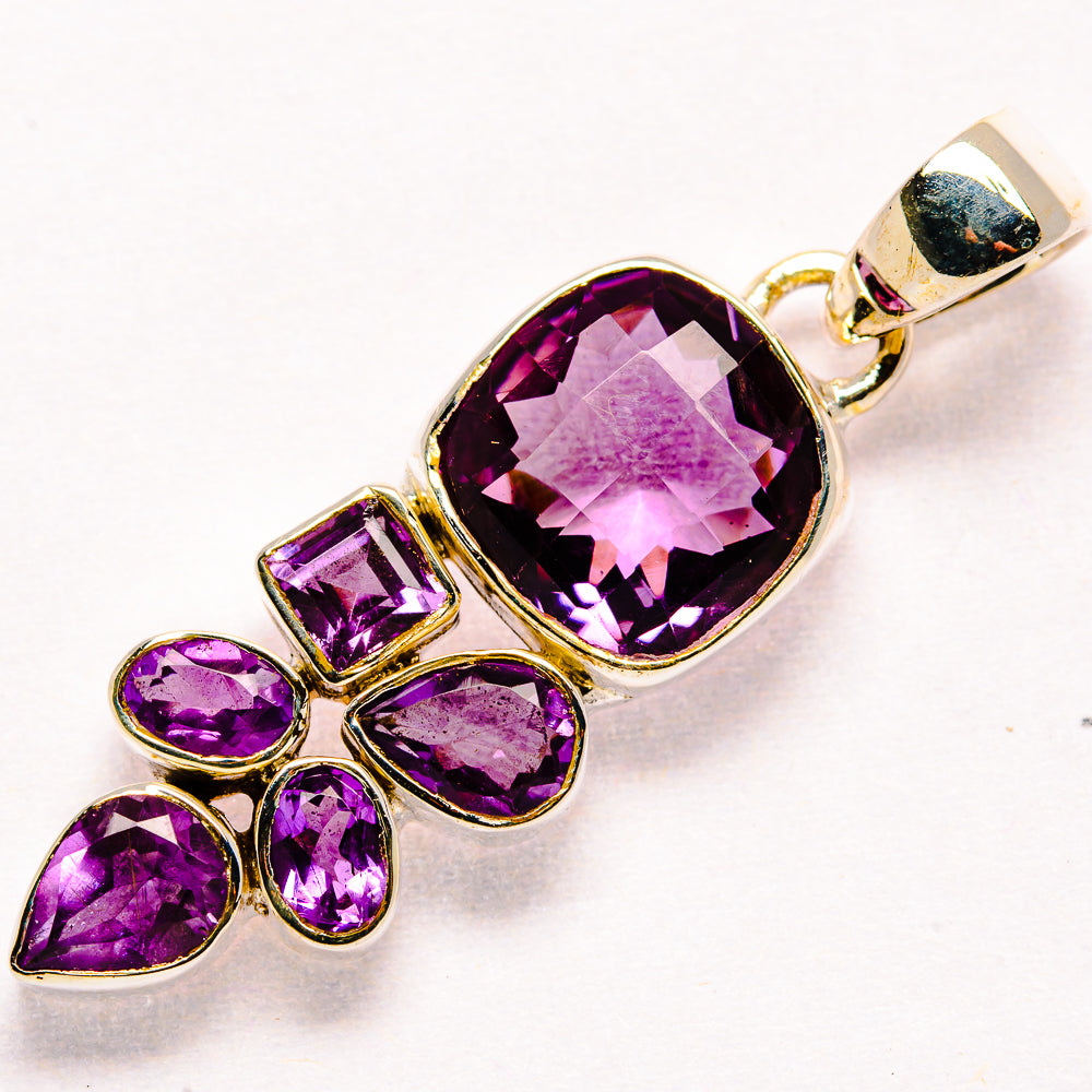 Sterling silver faceted amethyst pendant with large oval amethyst and four small stones