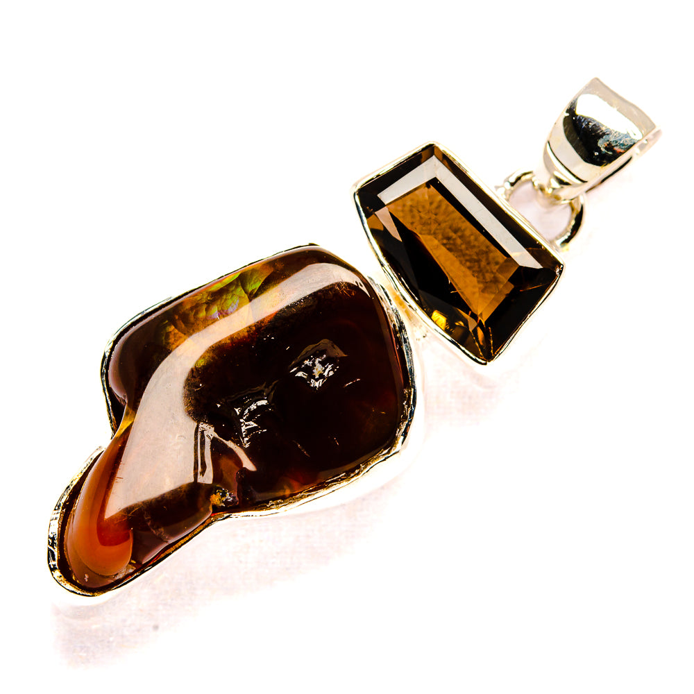 Sterling silver pendant with oval amber-brown stone and dark rectangular gem in bezel