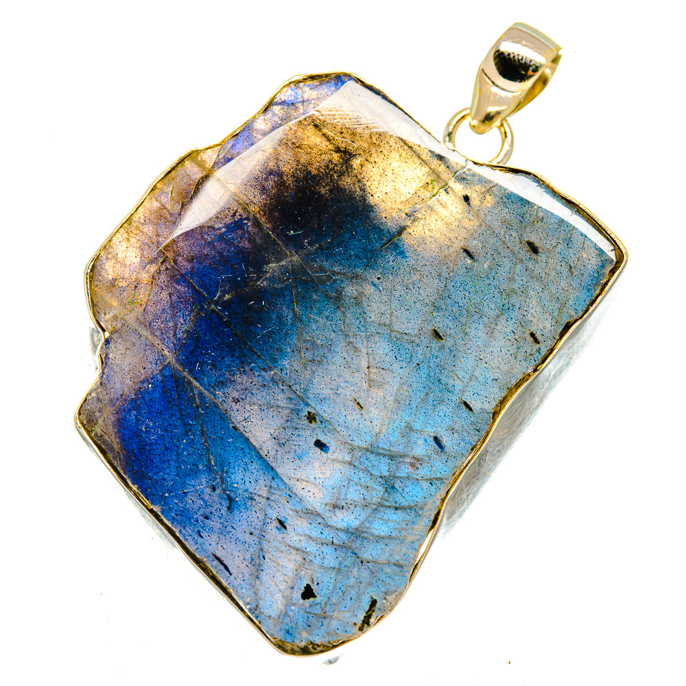 Rough labradorite pendant with gold-tone bail, blue stone in irregular silver frame