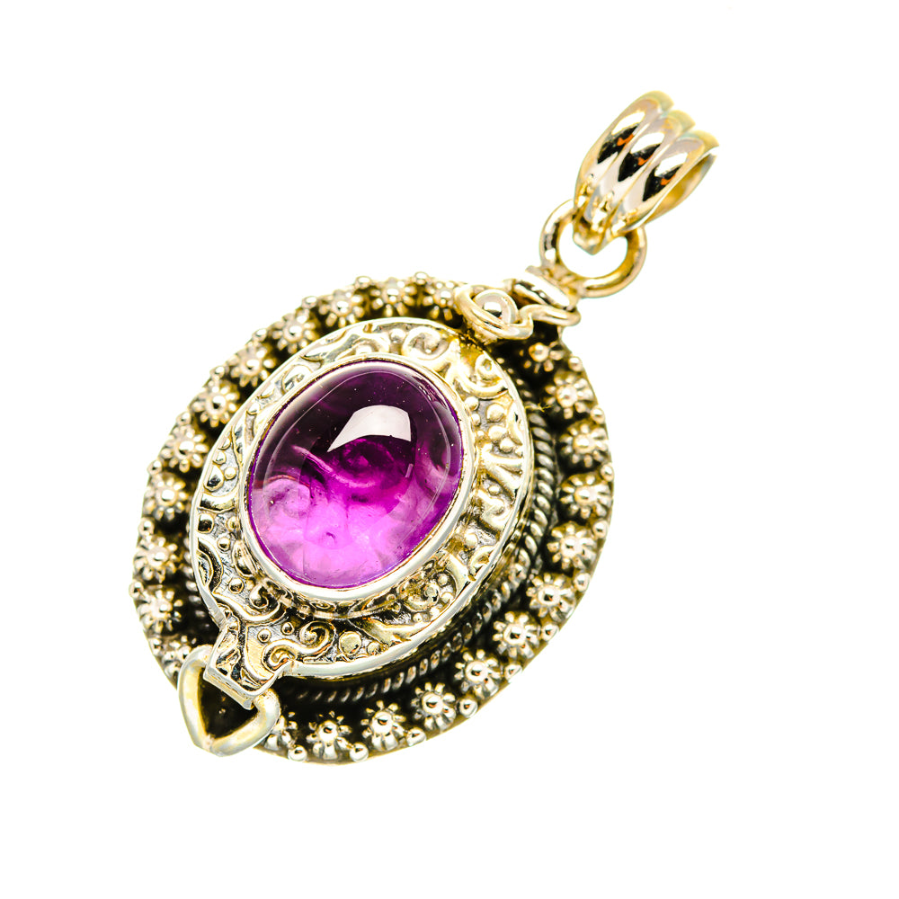 Oval amethyst pendant with detailed silver engraving and gold-tone top bail