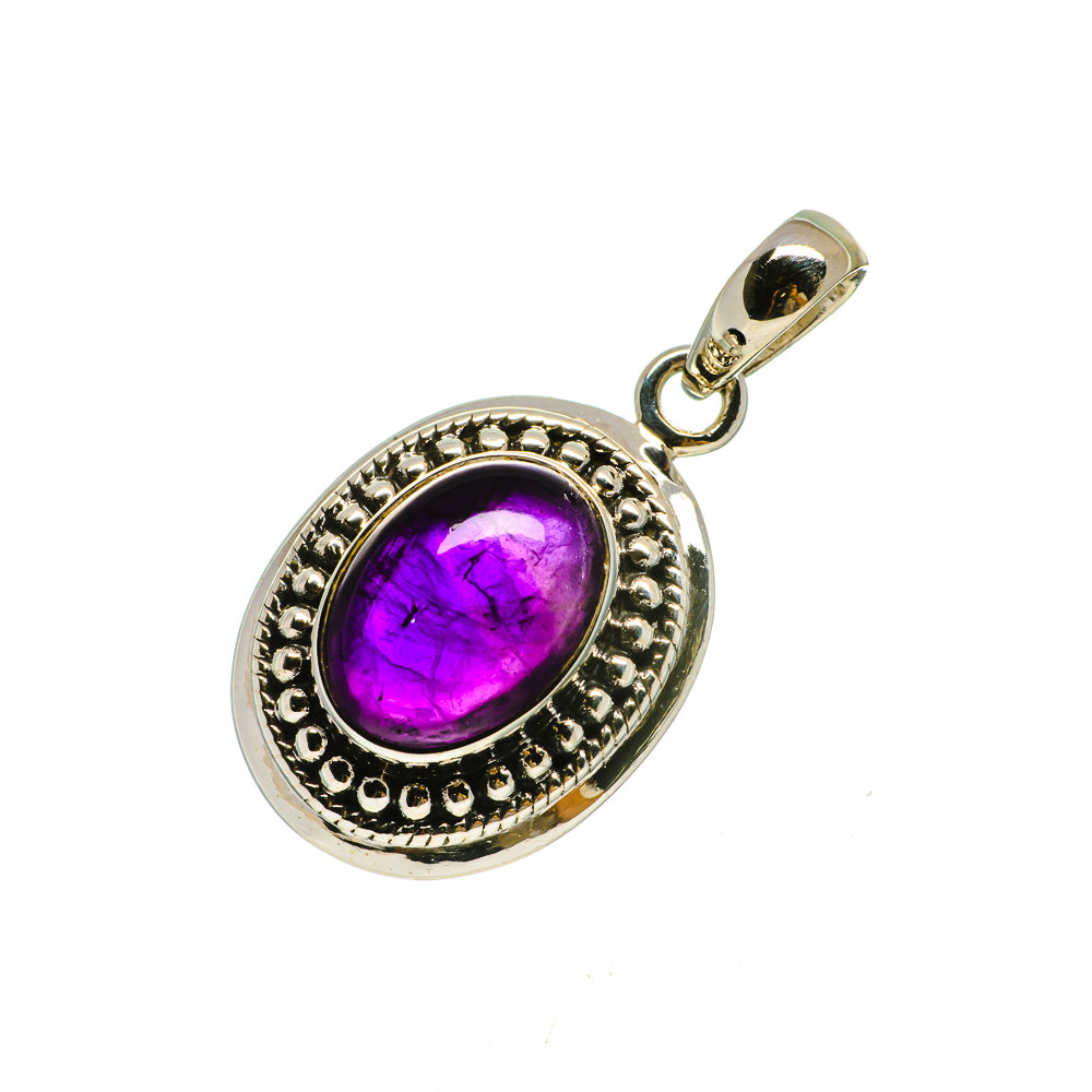 Sterling silver oval pendant with purple amethyst cabochon and decorative bezel
