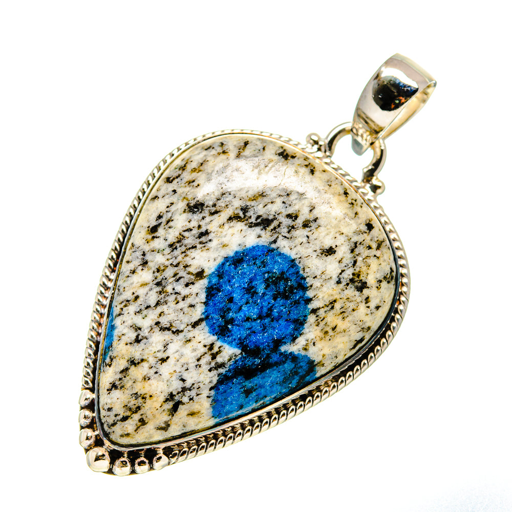 Teardrop stone pendant with blue markings in gold-tone silver setting