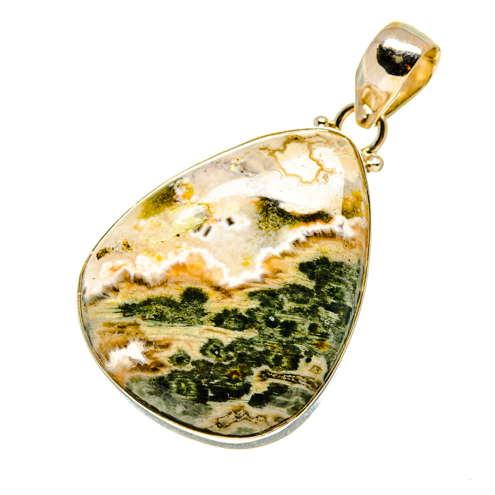 Oval ocean jasper pendant with silver bezel and gold-toned loop bail.